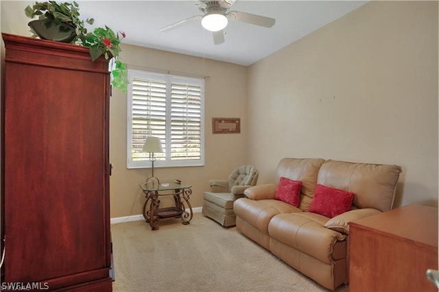 carpeted living room featuring ceiling fan