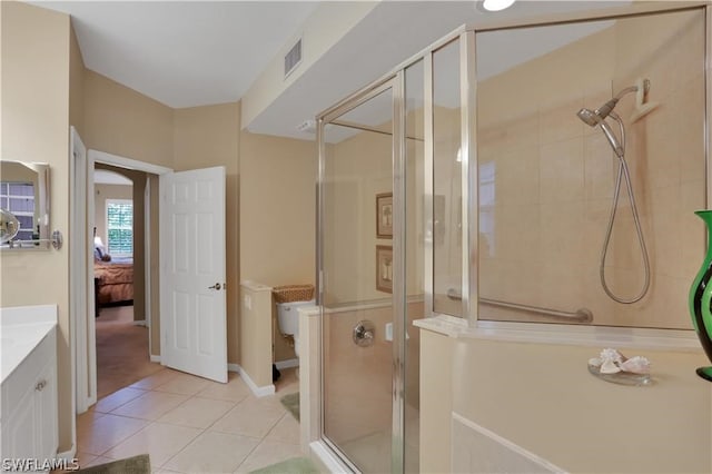 bathroom featuring tile floors, walk in shower, toilet, and vanity