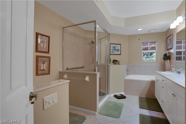 bathroom with tile floors, separate shower and tub, and large vanity