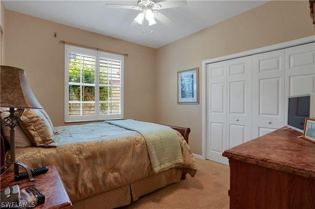 carpeted bedroom with ceiling fan and a closet