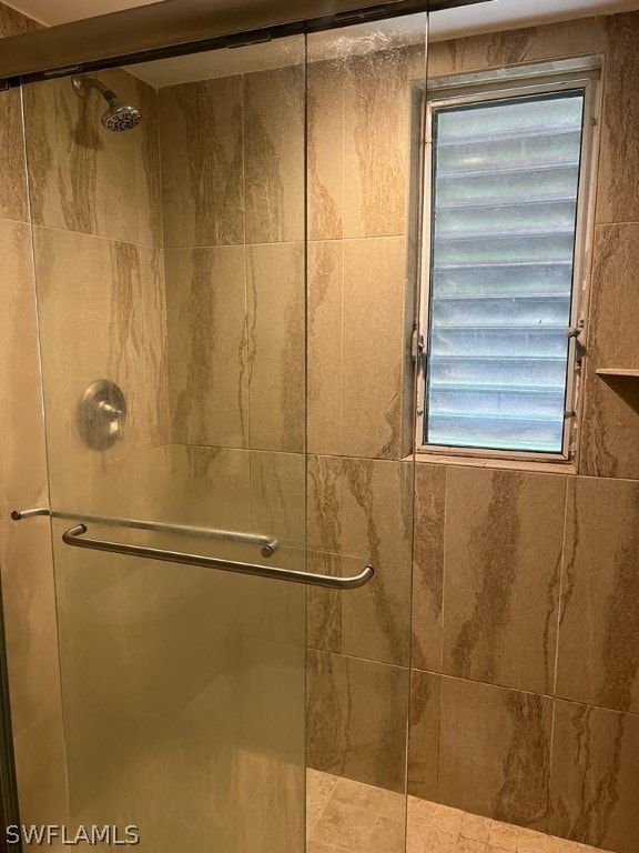 bathroom featuring a shower with door