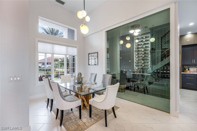 dining space with a towering ceiling