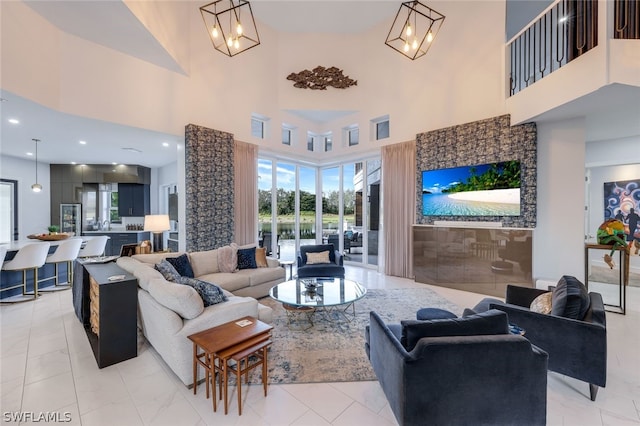 living room featuring a towering ceiling and an inviting chandelier