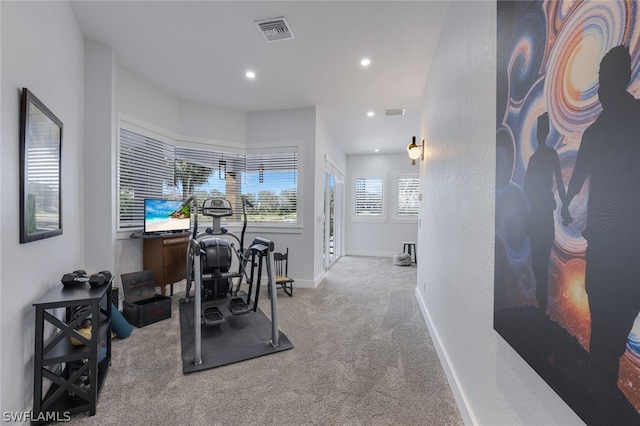 workout room featuring light colored carpet