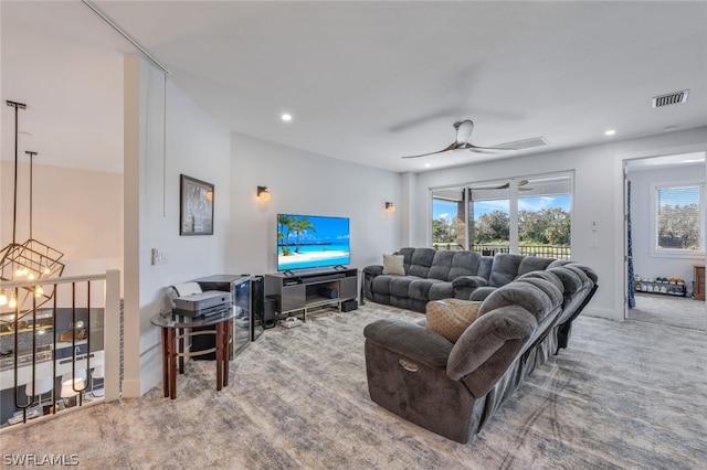 carpeted living room with ceiling fan