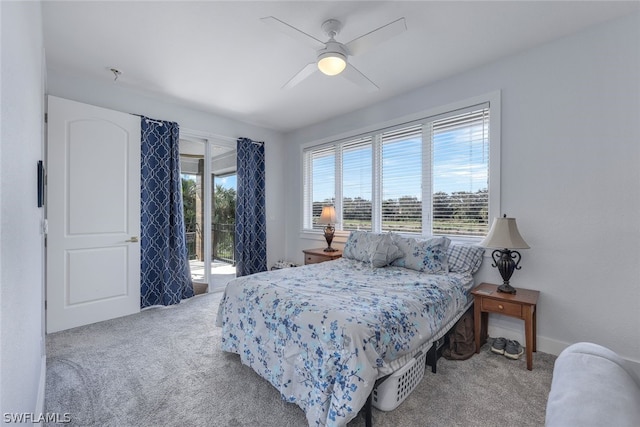 carpeted bedroom with ceiling fan, access to outside, and multiple windows