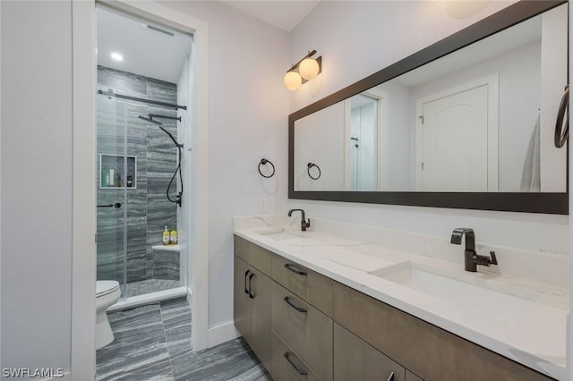 bathroom featuring vanity, an enclosed shower, and toilet