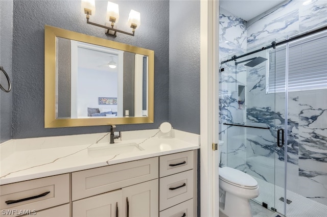 bathroom featuring vanity, toilet, and a shower with shower door