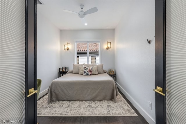 bedroom with ceiling fan and dark hardwood / wood-style floors