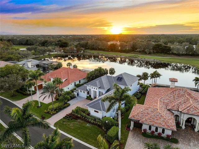 aerial view at dusk with a water view