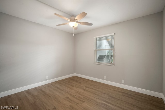 unfurnished room featuring ceiling fan and dark hardwood / wood-style floors