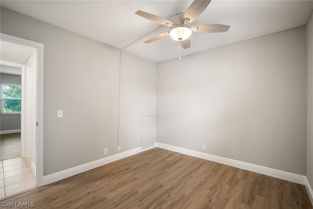 spare room featuring ceiling fan and tile floors