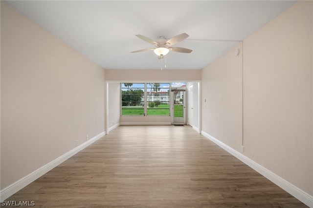 empty room with wood-type flooring and ceiling fan