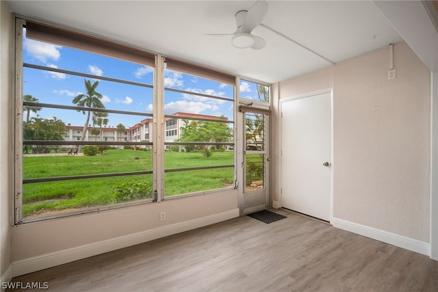 unfurnished room with ceiling fan, light hardwood / wood-style flooring, and a wealth of natural light