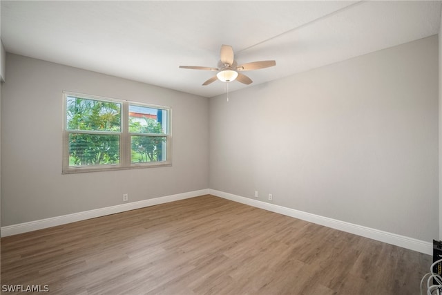 spare room featuring ceiling fan and hardwood / wood-style floors