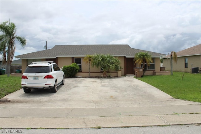 single story home featuring central AC unit and a front yard