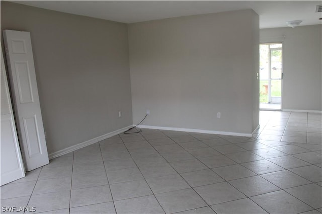 spare room featuring light tile patterned floors