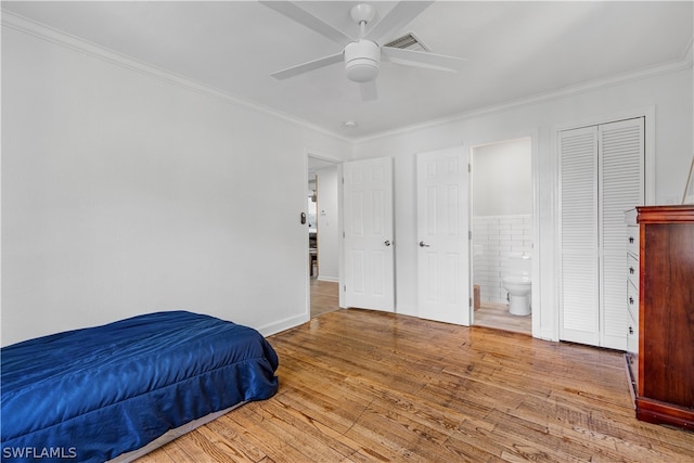 bedroom featuring wood-type flooring, crown molding, ceiling fan, and ensuite bathroom