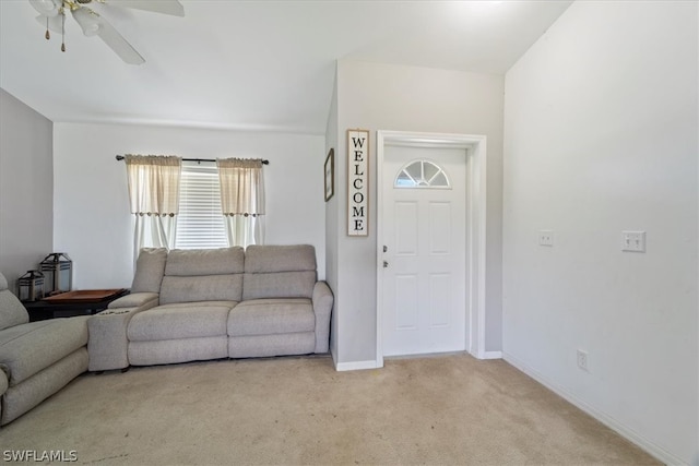 carpeted living room featuring ceiling fan