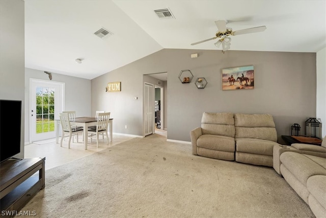 living room with ceiling fan, vaulted ceiling, and carpet flooring