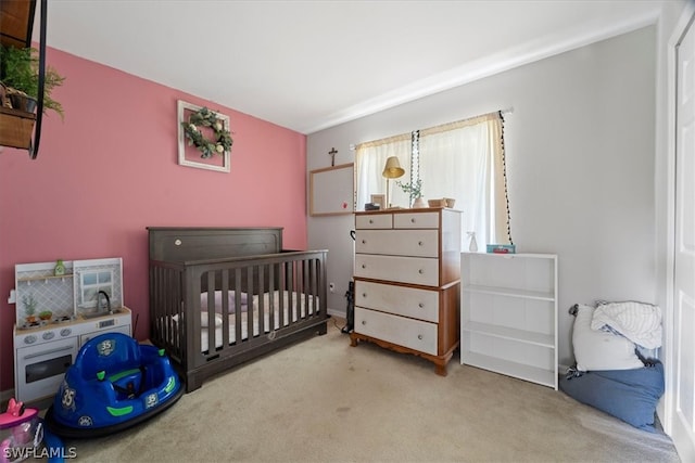 bedroom with a crib and carpet floors