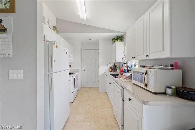 kitchen featuring lofted ceiling, white appliances, white cabinets, sink, and light tile floors