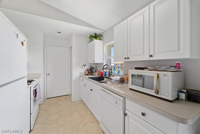 kitchen with vaulted ceiling, white cabinetry, sink, white appliances, and light tile floors