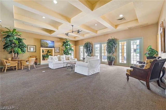 carpeted living room with beamed ceiling, coffered ceiling, and french doors