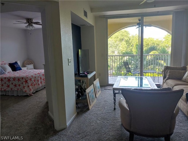 carpeted living room with ceiling fan