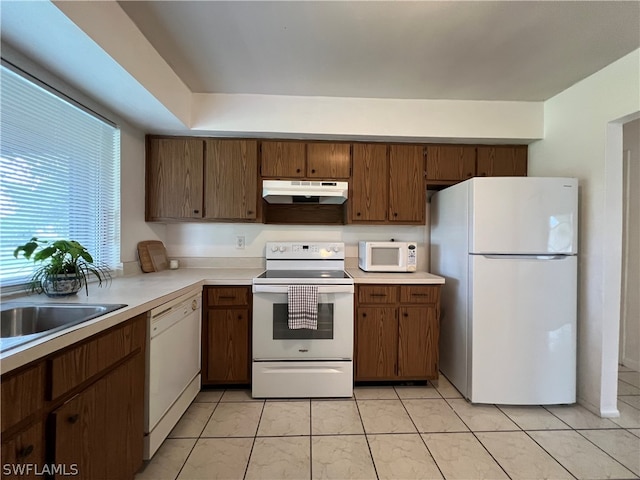 kitchen with light tile patterned flooring and white appliances