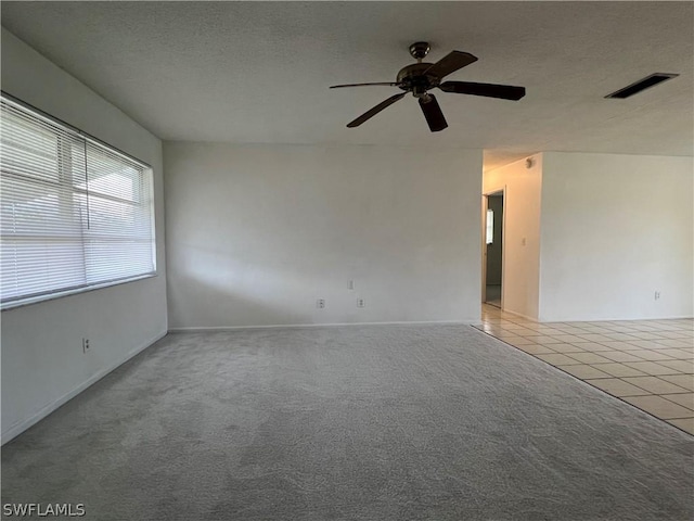 tiled empty room with ceiling fan