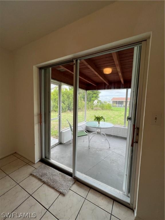 doorway to outside featuring light tile patterned floors