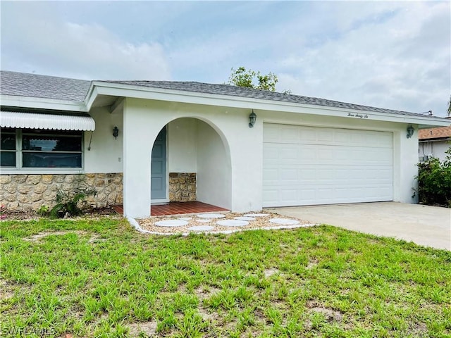 view of front of house with a garage and a front lawn