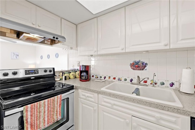 kitchen with backsplash, electric range, sink, and white cabinets