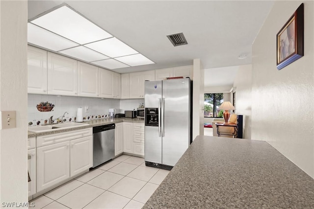 kitchen featuring white cabinetry, sink, and appliances with stainless steel finishes