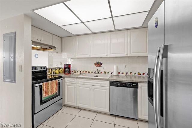 kitchen with extractor fan, appliances with stainless steel finishes, and white cabinetry