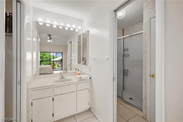 bathroom with tile patterned flooring, vanity, a shower with door, and ceiling fan