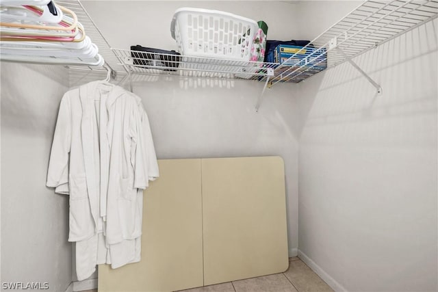 walk in closet featuring light tile patterned flooring