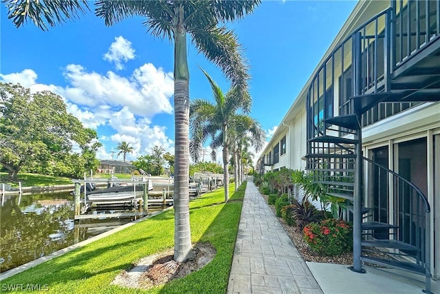 view of community with a boat dock and a water view