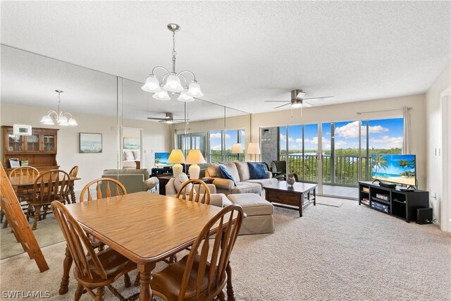 dining space with light colored carpet, a textured ceiling, and ceiling fan with notable chandelier