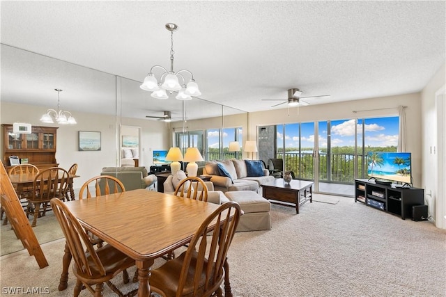 dining space with light carpet, ceiling fan with notable chandelier, and a textured ceiling