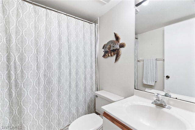 bathroom featuring vanity and toilet