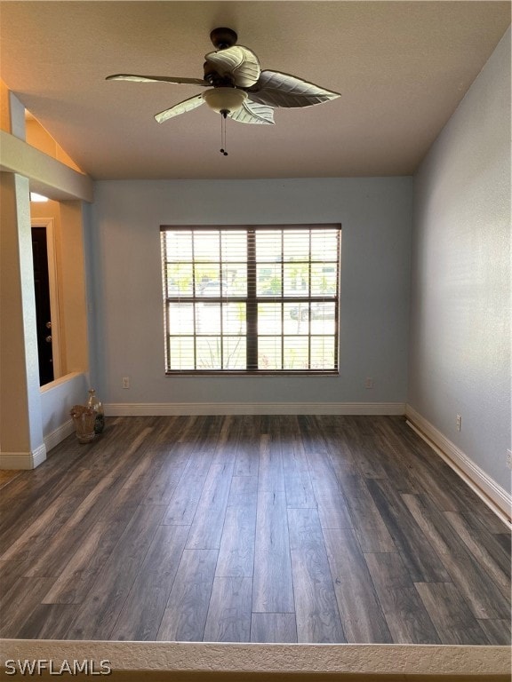 unfurnished room with dark hardwood / wood-style floors, a healthy amount of sunlight, and ceiling fan