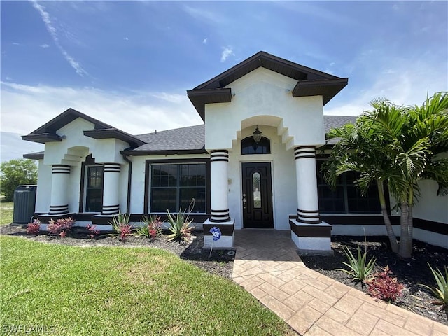 3606 NW 47th Ln, Cape Coral, FL 33993 - mediterranean / spanish home with roof with shingles, a front yard, and stucco siding