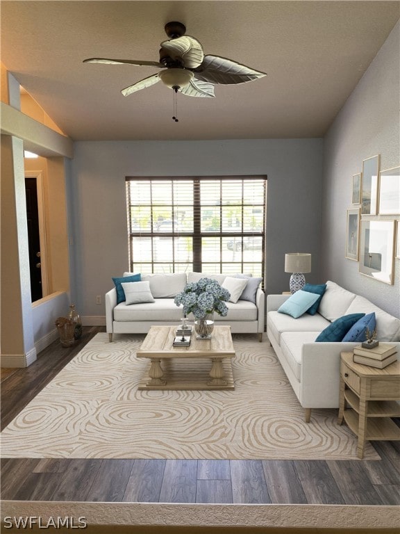 living room featuring hardwood / wood-style floors, ceiling fan, a healthy amount of sunlight, and vaulted ceiling