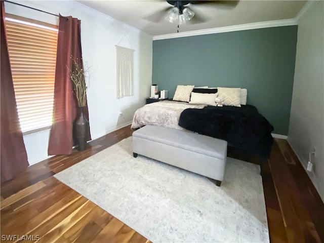 bedroom featuring crown molding, ceiling fan, and dark wood-type flooring