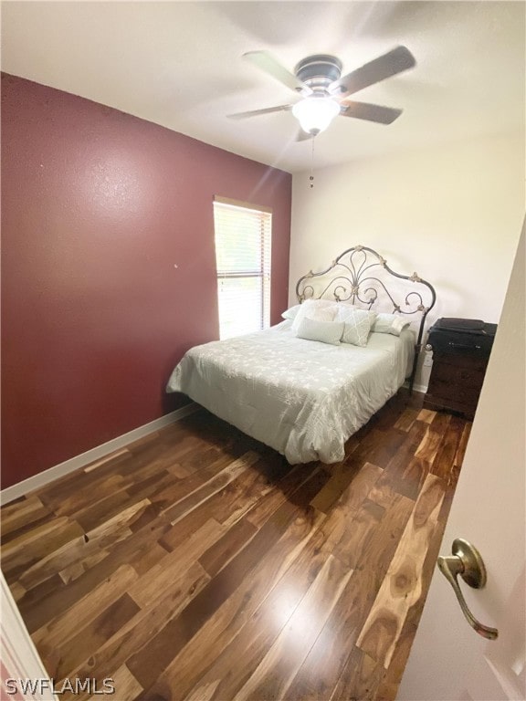 bedroom featuring ceiling fan and dark hardwood / wood-style flooring