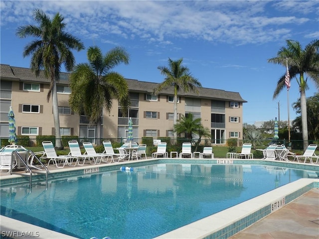 view of swimming pool with a patio area and fence