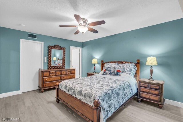 bedroom with ceiling fan and light wood-type flooring