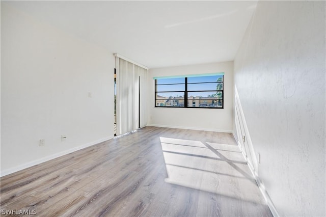 spare room featuring light wood-type flooring